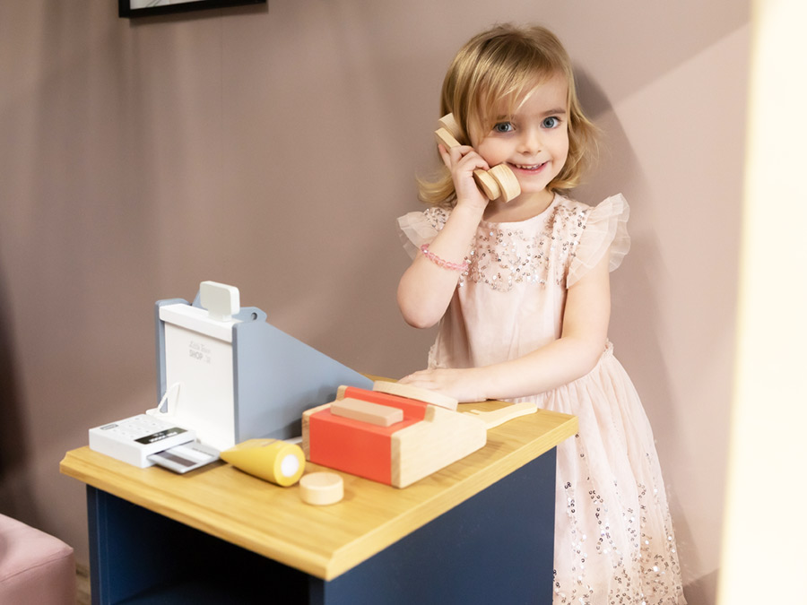 Child on play telephone at cash register